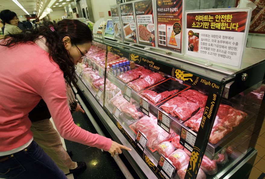 **FILE** South Korean customers look Nov. 27, 2008, at U.S. beef sold at a supermarket in Seoul. (Associated Press)