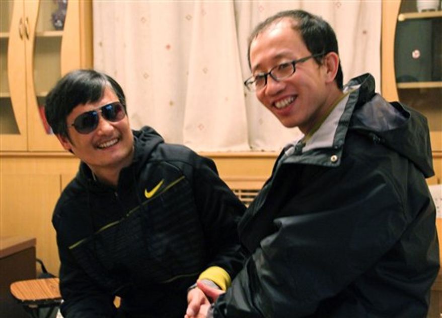 In this photo taken in late April, 2012, and provided by Hu Jia, blind Chinese legal activist Chen Guangcheng, left, meets with Hu at an undisclosed location. Chen, an inspirational figure in China's rights movement, slipped away from his well-guarded rural village on Sunday night, April 22, 2012, and made it to a secret location in Beijing on Friday, April 27, setting off a frantic police search for him and those who helped him, activists said. (AP Photo/Courtesy of Hu Jia)