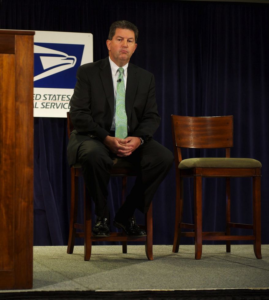 **FILE** Postmaster General Patrick R. Donahoe sits onstage during a Sept. 15, 2011, press conference. (Rod Lamkey Jr./The Washington Times)