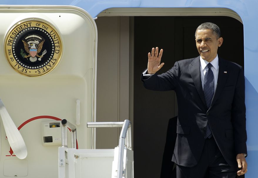 President Obama waves May 10, 2012, upon his arrival in Seattle. Obama was in town for fundraising events. (Associated Press)