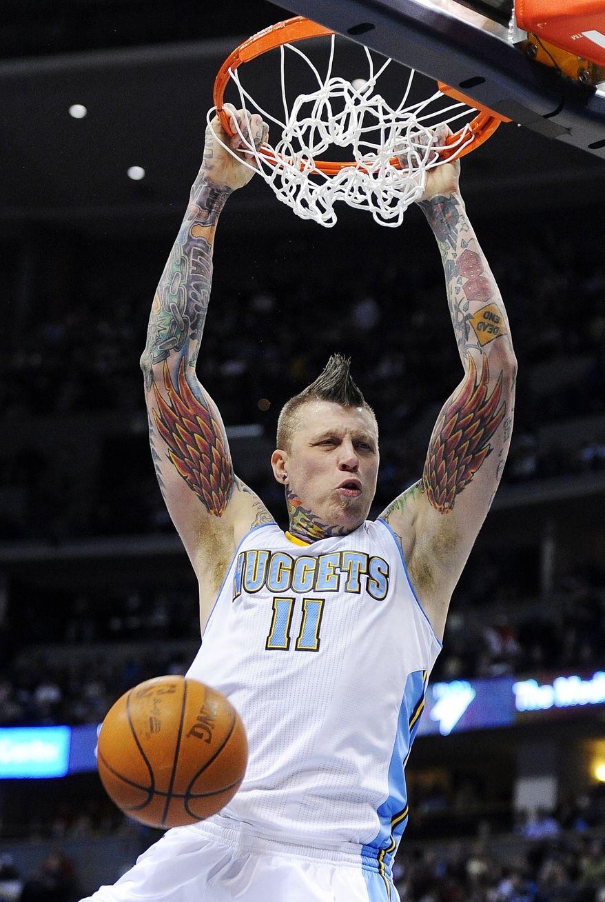 FILE - This March 25, 2011 file photo shows Denver Nuggets forward Chris Anderson dunking in the third quarter of an NBA basketball game against the Washington Wizards, in Denver. Douglas County sheriff's deputies have searched the home of the popular Nuggets center. Sheriff's spokesman Ron Hanavan confirmed that the search took place Thursday as part of an investigation conducted by the department's Internet Crimes Against Children unit. Andersen has not been arrested and Hanavan said no arrest warrant has been issued. (AP Photo/Chris Schneider, File)