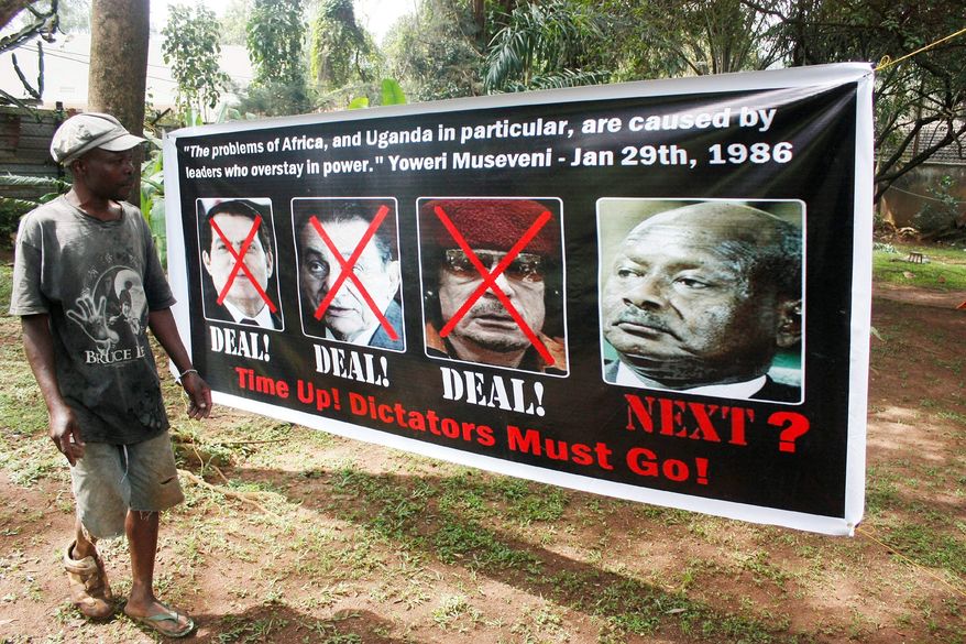 A member of Uganda's opposition ties up a banner in Uganda's capital Kampala Thursday, Sept. 8, 2011, showing former long serving presidents, left to right, Ben Ali (Tunisia), Hosni Mubarak (Egypt), Moummar Gaddafi (Libya) and current Ugandan president Yoweri Museveni in preparation for celebrations for the downfall of these leaders, in Kampala on Friday. Uganda Police has warned that they will arrest whoever turns up for the celebrations. Other long serving African leaders are Mbasago of Equatorial Guinea (32 years since 1979), Jose Santos of Angola (32 years since 1979), Robert Mugabe of Zimbabwe (31 years since 1980), Paul Biya of Cameroon (29 years since 1982), Blaise Campore of Burkina Fasso ( 24 years since 1987), Mswati III of Swaziland (24 years since April 1986), Omar Bashir of Sudan ( 21 years since 1989), Idrissu Deby of Chad ( 21 years since 1990), Isaias Afewerki of Eritrea ( 18 years since 1993), Yahya Jammeh of Gambia (17 years since 1994) , Meles Zenawi of Ethiopia (16 years since 1995) , Pakalitha Mosisili of Lesotho (13 years since 1998), Ismail Omar Guelleh of Djibouti ( 12 years since 1999), Mohammed VI of Morocco (12 years since 1999), Abdoulaye Wade of Senegal ( 11 years since 2000) and Paul Kagame of Rwanda (11 years since 2000). (AP Photo / Stephen Wandera)