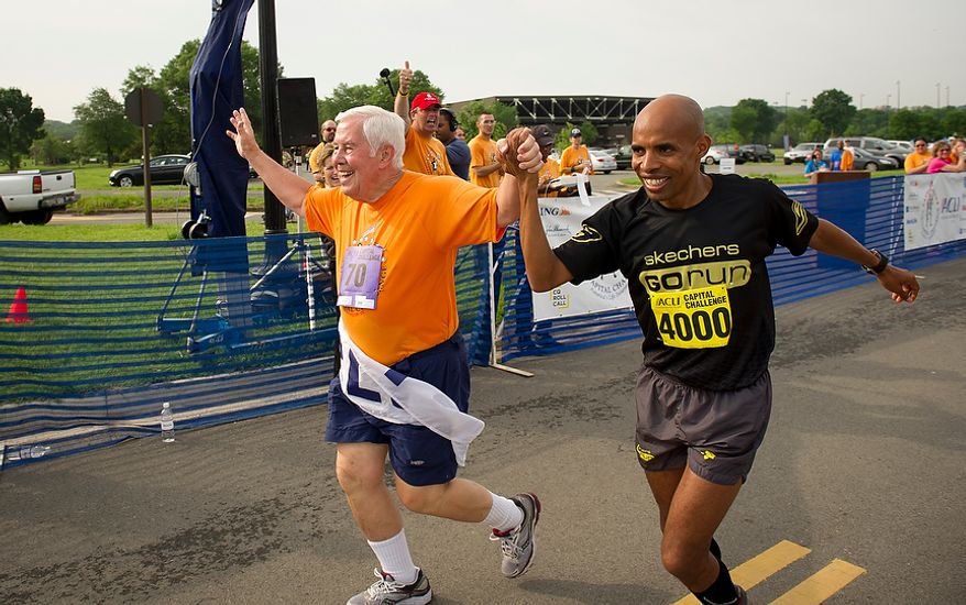 Senator Richard Lugar (R-Ind.) is joined by 2004 Olympic Silver Medalist Meb Keflezighi (#4000) as they cross the finish line together during the ACLI Capital Challenge at Anacostia Park in Washington, D.C., Wednesday, May 16, 2012. This is the 31st running of the three-mile race where members of Congress, national media outlets and locals take part in this fundraising event in the early morning hours along the water of the Anacostia River. (Rod Lamkey Jr/The Washington Times)