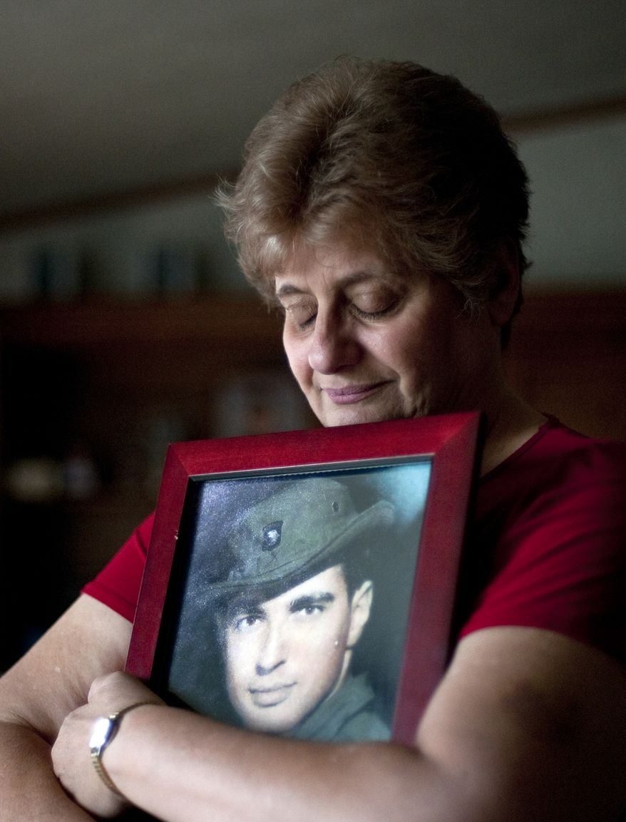 Rose Mary Sabo-Brown holds a photo of her husband, Army Spec. Leslie H. Sabo Jr., at her home in New Castle, Pa., on Thursday, May 10, 2012. (AP Photo/Andrew Russell, Tribune-Review)
