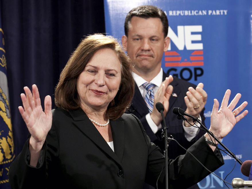 **FILE** Nebraska state Sen. Deb Fischer addresses supporters May 16, 2012, as her former opponent, state Attorney General Jon Bruning, applauds. (Associated Press)