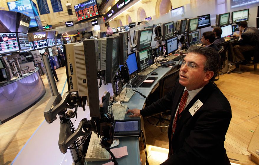 **FILE** Trader John Bishop works May 7, 2012, on the floor of the New York Stock Exchange. (Associated Press)