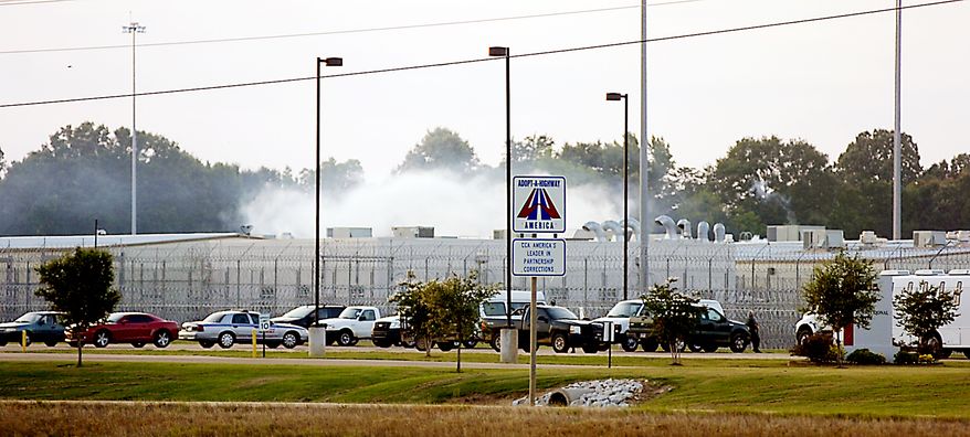 Smoke rises above the Adams County Correctional Center in Natchez, Miss., on Sunday, May 20, 2012, during an inmate disturbance. (AP Photos/Natchez Democrat, Lauren Wood)