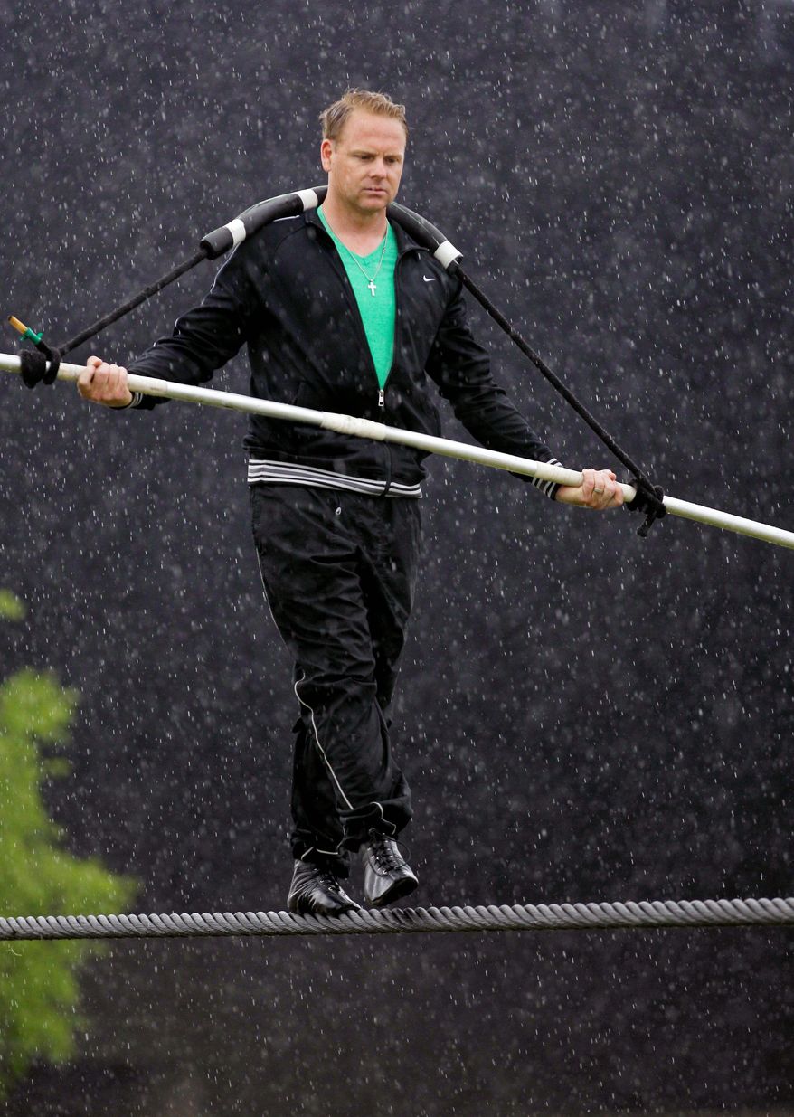 Nik Wallenda performs a walk on a tightrope in the rain during training for his walk over Niagara Falls in Niagara Falls, N.Y., earlier this month. (Associated Press)