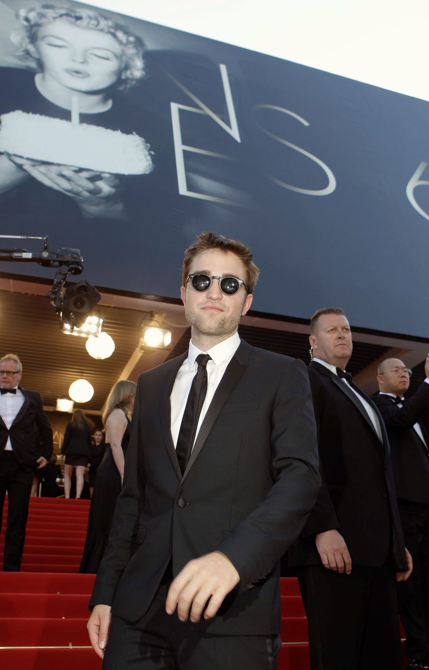 "People aren't thinking of me as a kid anymore, so I've got to stop behaving like one," said Robert Pattinson, shown arriving for the screening of "On the Road" on Wednesday at the Cannes Film Festival. (Associated Press)