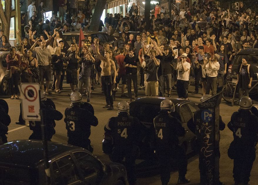 Protesters and riot police face off in Montreal on Thursday, May 24, 2012, during a march to protest university tuition fee increases. (AP Photo/Ryan Remiorz, Canadian Press)