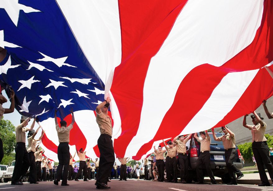 R.O.T.C students unfurl a large American flag at the start of the Memorial Day Parade on Constitution Avenue, Washington, D.C., Monday, May 28, 2012. (Andrew Harnik/The Washington Times)