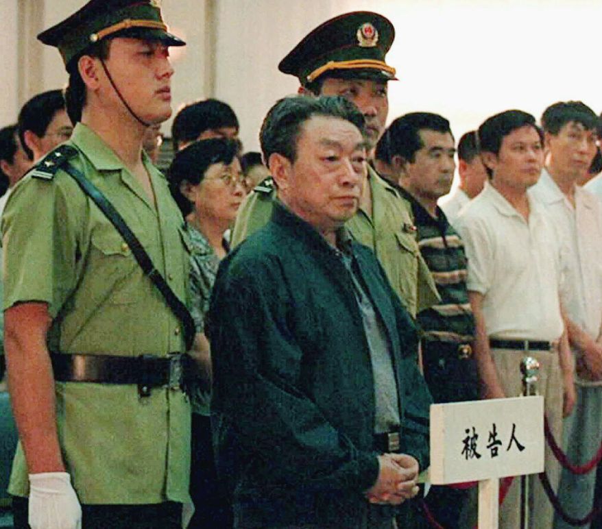 Former Beijing Mayor Chen Xitong (center) stands in Municipal Higher Peoples Court in Beijing in July 1998. Chen was deposed as Beijing's Communist Party boss for corruption and is serving a 16-year prison sentence. (AP Photo/Xinhua News Agency)