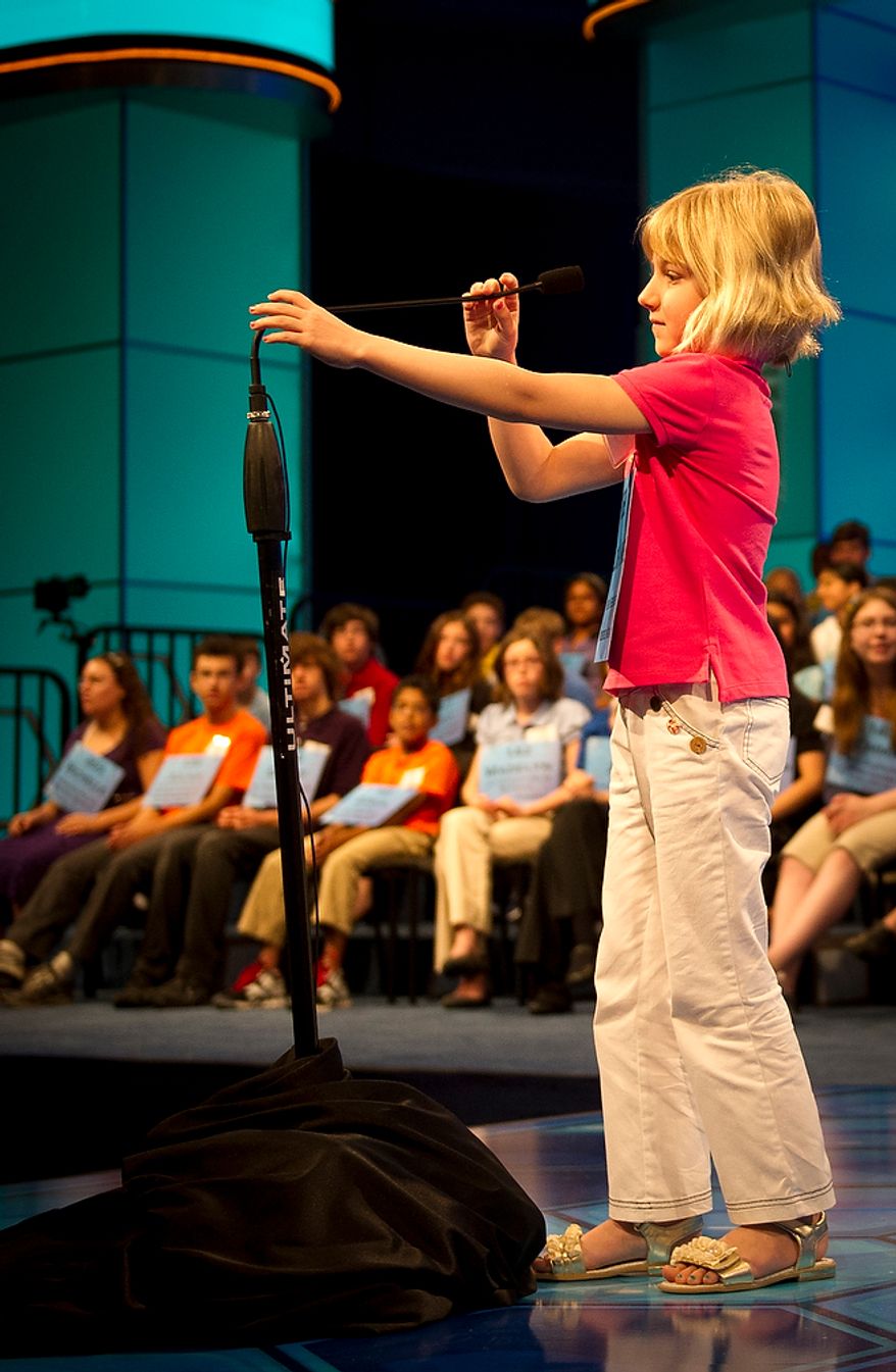 Six year-old Lori Anne C. Madison of Woodbridge, Va., works on adjusting the height of the tall microphone during round two of the 2012 Scripps National Spelling Bee at the Gaylord National Resort and Convention Center in National Harbor, Md., Wednesday, May 30, 2012. This year, 278 spellers from around the United States and all walks of life will compete for the title of 2012 Scripps National Spelling Bee champion. Lori Anne spelled her word, dirigible, correctly. (Rod Lamkey Jr/The Washington Times)