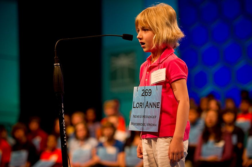 Six year-old Lori Anne C. Madison of Woodbridge, Va., works on spelling her word during the preliminary rounds of the 2012 Scripps National Spelling Bee at the Gaylord National Resort and Convention Center in National Harbor, Md., Wednesday, May 30, 2012. This year, 278 spellers from around the United States and all walks of life will compete for the title of 2012 Scripps National Spelling Bee champion. Lori Anne spelled her word, dirigible, correctly. (Rod Lamkey Jr/The Washington Times)