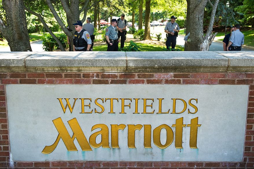 Police officers stand guard at the entrance to the Marriott Westfields where the annual Bilderberg Conference is being held, Chantilly, Va., Thursday, May 31, 2012. The Bilderberg Conference is an annual meeting of highly influential people in private industry and public office from North America and Western Europe. (Andrew Harnik/The Washington Times)