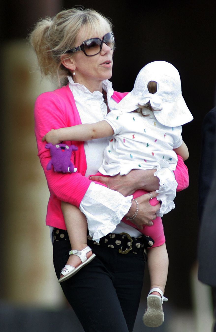 ** FILE ** In this Aug. 6, 2009, file photo, Rielle Hunter, mistress of former U.S. senator and presidential candidate John Edwards, leaves the Terry Sanford Federal Building and Courthouse in Raleigh, N.C. (AP Photo/Jim R. Bounds, File)