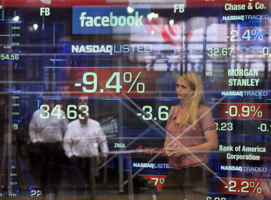 **FILE** Television correspondent Sabrina Quagliozzi reports May 21, 2012, from inside the Nasdaq MarketSite in New York's Times Square. (Associated Press)