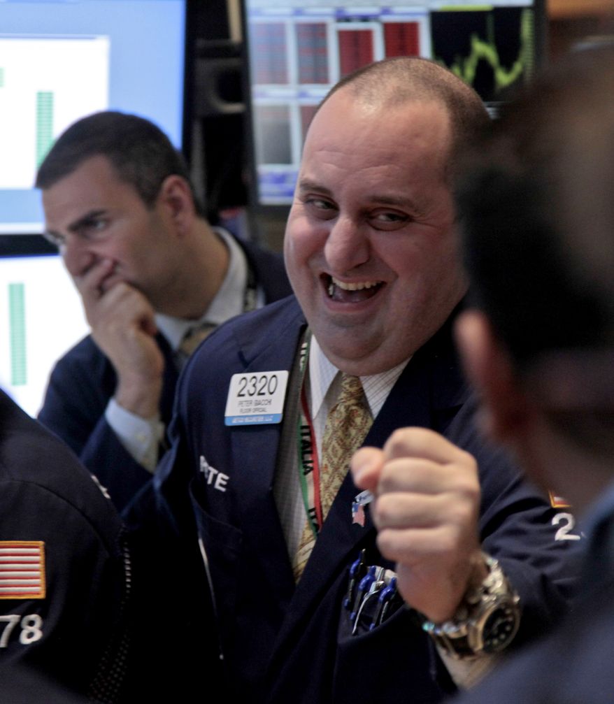 Getco Securities trader Philip Finale (left) and its floor official Peter Giacchi (right) work June 6, 2012, on the floor of the New York Stock Exchange. (Associated Press)