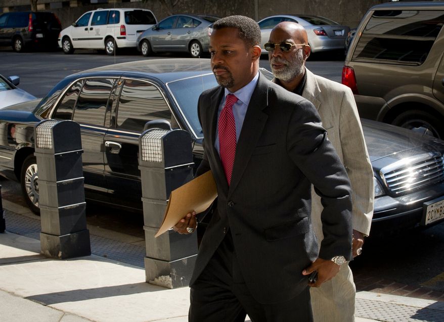 Former D.C. Council Chairman Kwame R. Brown (left) enters the E. Barrett Prettyman Federal Courthouse for his plea hearing in Washington, D.C., Friday, June 8, 2012. (Rod Lamkey Jr/The Washington Times)