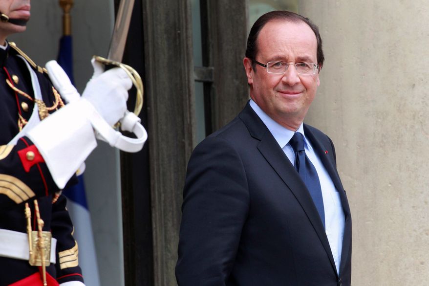 French President Francois Hollande prepares for a meeting with his counterpart from Niger, Issoufou Mahamadou, at the Elysee Palace in Paris on Monday. Mr. Hollande, who was elected last month, wants his political kin to control the powerful lower house of Parliament for the next five years so he can move forward with plans to strengthen the state's role in the economy, create thousands of teaching jobs and tackle high youth joblessness.