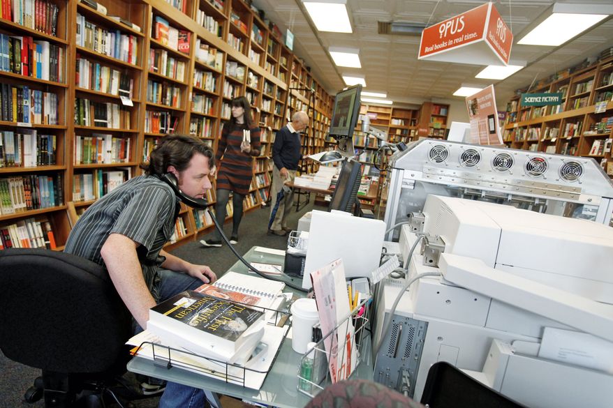 Bill Leggett works on the Espresso Book Machine, known as Opus, at Politics and Prose bookstore in Washington, D.C., earlier this month. Self-publishing has been made easier since the machine by On Demand Books debuted in 2006. (Associated Press)