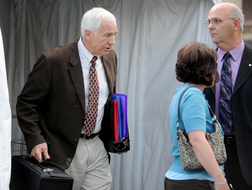 Jerry Sandusky, left, leaves the Centre County Courthouse and walks toward his attorney Joe Amendola's car Thursday, June 14, 2012, in Bellefonte, Pa. The prosecution's case in Sandusky's sex abuse trial neared its conclusion on Thursday after just four days of testimony, with three more accusers taking the witness stand, including a young man who said the former Penn State assistant football coach raped him as a teen guest in Sandusky's home. (AP Photo/Centre Daily Times, Abby Drey)