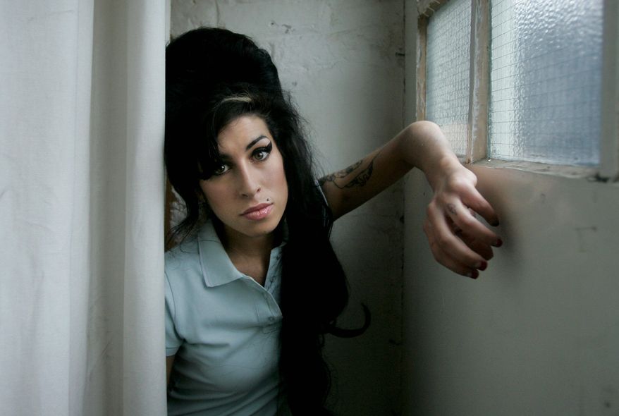 FILE - In this Feb. 16, 2007 file photo, British singer Amy Winehouse poses for photographs at a studio in north London. Mitch Winehouse, father of the late singer Amy Winehouse, says he has a hard time enjoying her breakthrough "Back to Black" album because the songs are about her ex-husband. Winehouse blames Blake Fielder-Civil for leading her into drug abuse, and he details her long decline in a new memoir, "Amy, My Daughter." (AP Photo/Matt Dunham, File)