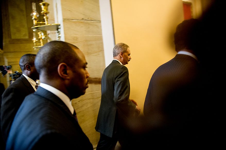 Attorney General Eric H. Holder Jr. leaves after speaking to the media at the U.S. Capitol in Washington on Tuesday, June 19, 2012. Mr. Holder met with Rep. Darrell E. Issa, California Republican and chairman of the House Oversight and Government Reform Committee, to try to reach an agreement about Justice Department documents relating to the botched anti-gunrunning operation known as Fast and Furious. (Andrew Harnik/The Washington Times)