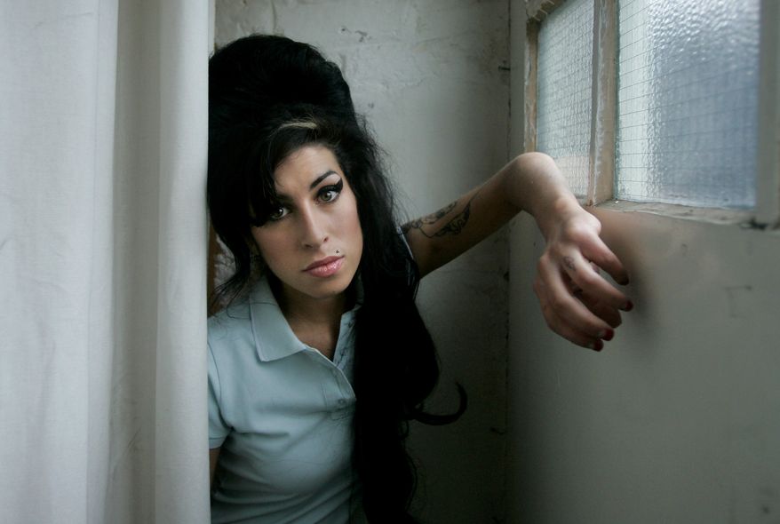 **FILE** British singer Amy Winehouse poses for photographs at a studio in north London in February 2007. (Associated Press