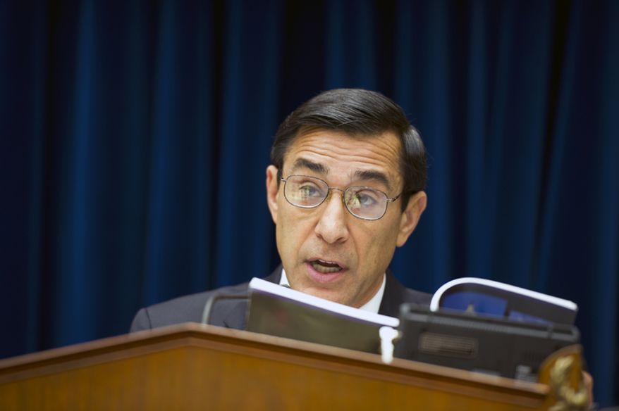 ** FILE ** Rep. Darrell E. Issa, California Republican and chairman of the House Committee on Oversight and Government Reform, reads from a book on June 20, 2012, at the Rayburn House Office Building on Capitol Hill, quoting the president's right to assert executive privilege after learning that President Obama has done so in the "Fast and Furious" gun-tracking case, refusing to turn over related documents to Congress. The committee proceeded with its markup to vote on whether to hold Attorney General Eric H. Holder Jr. in contempt for his failure to produce those documents. (Barbara L. Salisbury/The Washington Times)