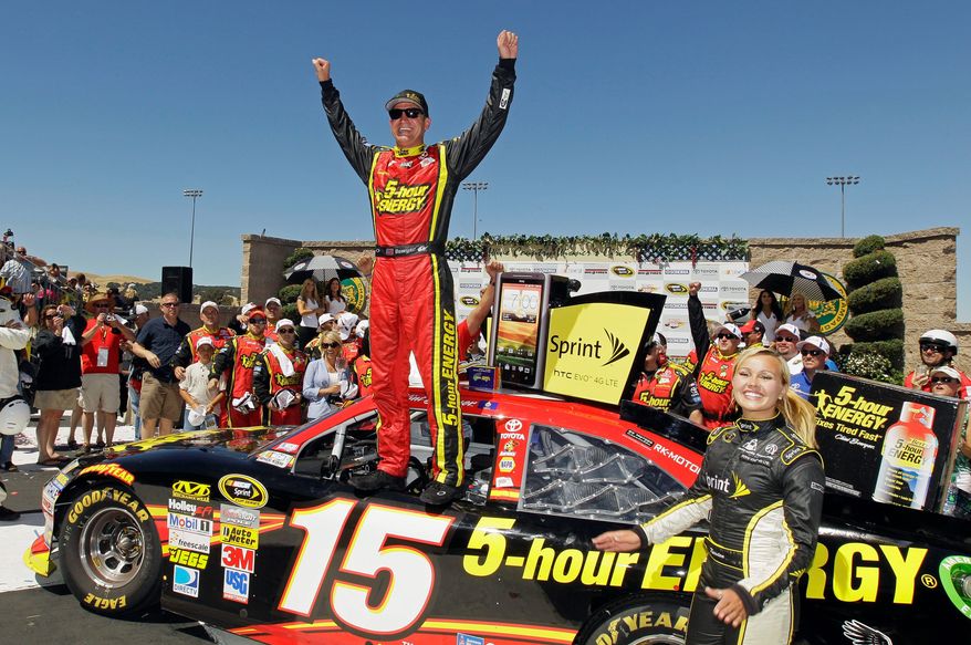 Clint Bowyer celebrates on top of his car after winning the NASCAR Sprint Cup Series auto race, Sunday, June 24, 2012, in Sonoma, Calif. (AP Photo/Eric Risberg)