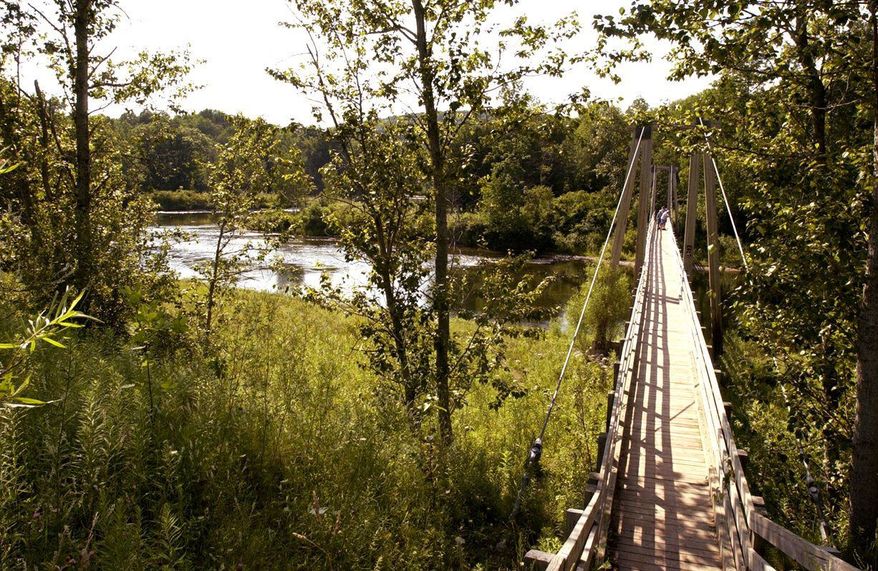 A suspension bridge over the Manistee River southeast of Mesick, Mich., is located on the North Country Scenic Trail. The North Country National Scenic Trail runs 4,600 miles from North Dakota to New York's eastern border. From there, it's about 40 miles across Vermont fields and mountains to the Appalachian Trail. Closing the 40-mile gap is a priority for the Michigan-based North Country Trail Association, the group responsible for the trail. (Associated Press)