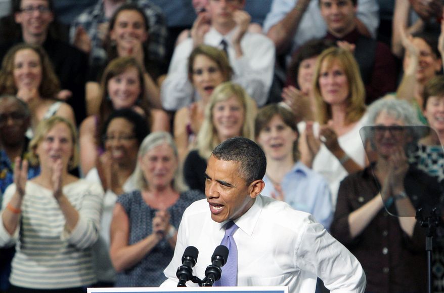 President Obama speaks at the Oyster River High School gym in Durham, N.H., on Monday. Mr. Obama appeared ebullient despite the overwhelming heat inside the gym. (Associated Press)