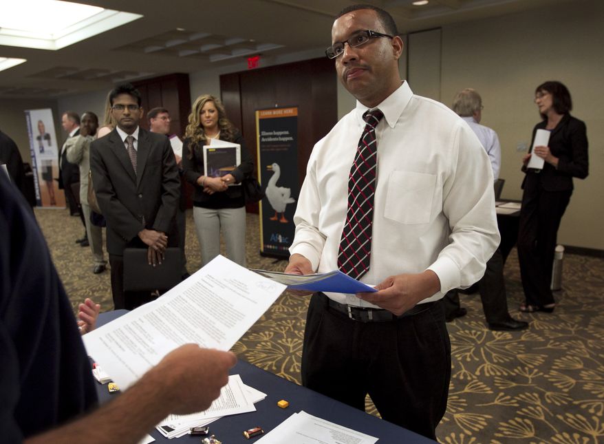 Trey Fortes (right) speaks with Jason Monteiro (left) of Hudson, Mass., during a job fair in Boston on Monday, June 18, 2012. (AP Photo/Steven Senne)
