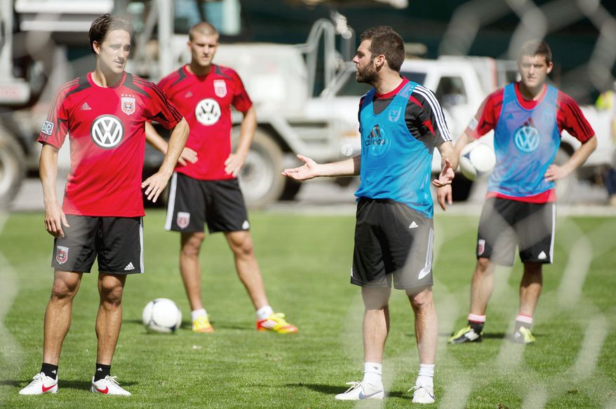 Forward Josh Wolff (left), shown with D.C United coach Ben Olsen (second from right) in March, has scored 80 goals in 265 games during his 14-year MLS career. (Andrew Harnik/The Washington Times)