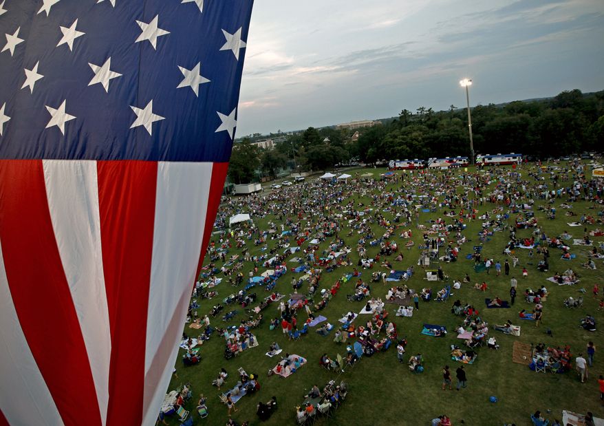 **FILE** A U.S. flag flies July 3, 2012, over a field during the Fanfare and Fireworks celebration at the University of Florida in Gainesville, Fla. (Associated Press/The Gainesville Sun)