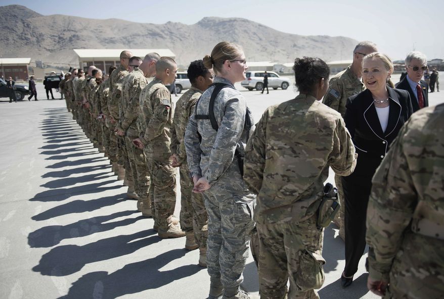 U.S. Secretary of State Hillary Rodham Clinton, right, greets troops before departing Kabul International Airport Saturday July 7, 2012. (AP Photo/Brendan Smialowski, Pool)