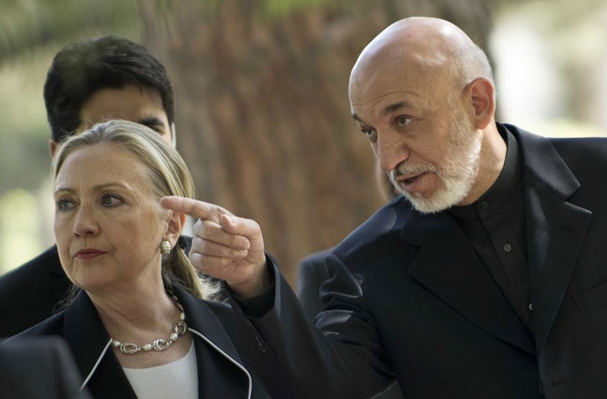 U.S. Secretary of State Hillary Rodham Clinton, left, walks with President of Afghanistan Hamid Karzai to a press conference at the Presidential Palace in Kabul, Saturday, July 7, 2012. (AP Photo/Brendan Smialowski, Pool)