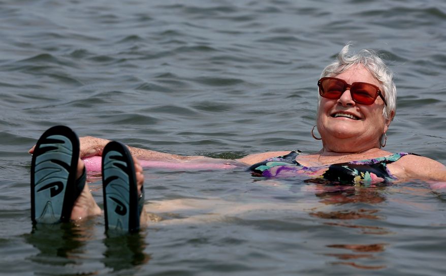 Lillian Mariscalo of Oyster Bay, N.Y., cools off in the waters of an Oyster Bay beach on Long Island's North shore Saturday, July 7, 2012. The heat gripping much of the country was set to peak Saturday in several places, with temperatures of more than 100 degrees expected in Philadelphia, excessive heat warnings in the Midwest and ongoing power outages of more than a week in the mid-Atlantic. (AP Photo/Craig Ruttle)