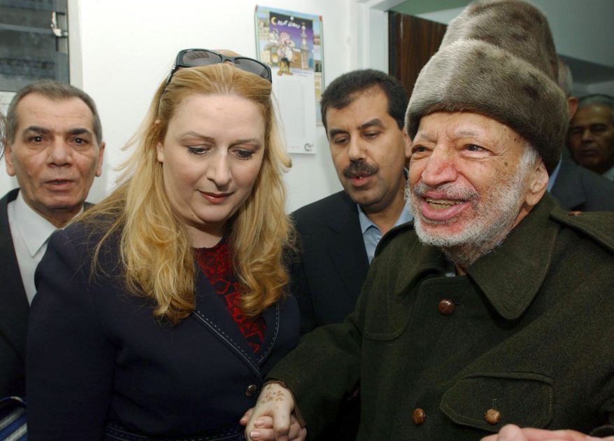 ** FILE ** Palestinian leader Yasser Arafat and his wife, Suha, hold hands before his departure from his compound in the West Bank town of Ramallah in October 2004. (AP Photo/Palestinian Authority, Hussein Hussein)