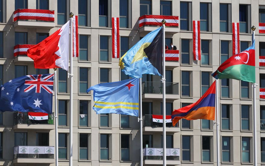 National flags fly in the Olympic Village ahead of the Summer 2012 Olympics on Thursday, July 26, 2012, in London. The opening ceremonies for the 2012 London Olympics will be held Friday, July 27. (AP Photo/Alexander Hassenstein, Pool)