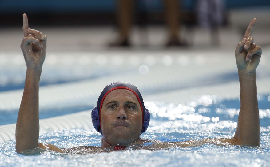 Adam Wright of the United States reacts after scoring against Montenegro in a preliminary water polo match at the 2012 Summer Olympics, Sunday, July 29, 2012, in London. The U.S. won 8-7. (AP Photo/Julio Cortez)