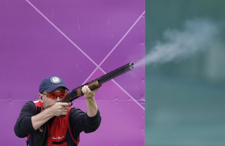 ** FILE ** U.S. skeet shooter Vincent Hancock fires July 31, 2012, during the men's skeet event at the 2012 Summer Olympics in London. Hancock finished first to win the gold medal. (Associated Press)