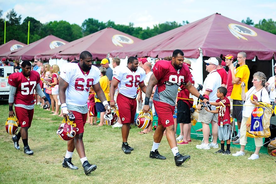 From left to right, Donnell Holt (#57), Willie Smith (#69), Darrel Young (#36), and Doug Worthington (#90) take the field during Redskins' training camp at Redskins Park, Ashburn, Va., Monday, July 30, 2012. (Ryan M.L. Young/The Washington Times)
