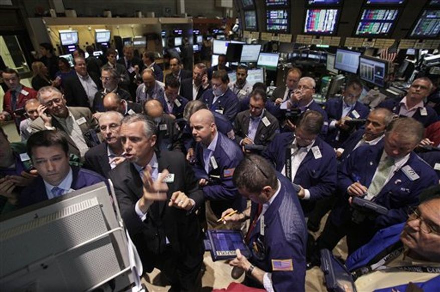 Specialist Donald Himpele, foreground second left, resumes trading in AIG stock on the floor of the New York Stock Exchange Friday, Aug. 3, 2012. The U.S. government says it plans to sell $4.5 billion in American International Group common stock, the latest effort to recoup taxpayer money spent on the largest bailout of the 2008 financial crisis. (AP Photo/Richard Drew)