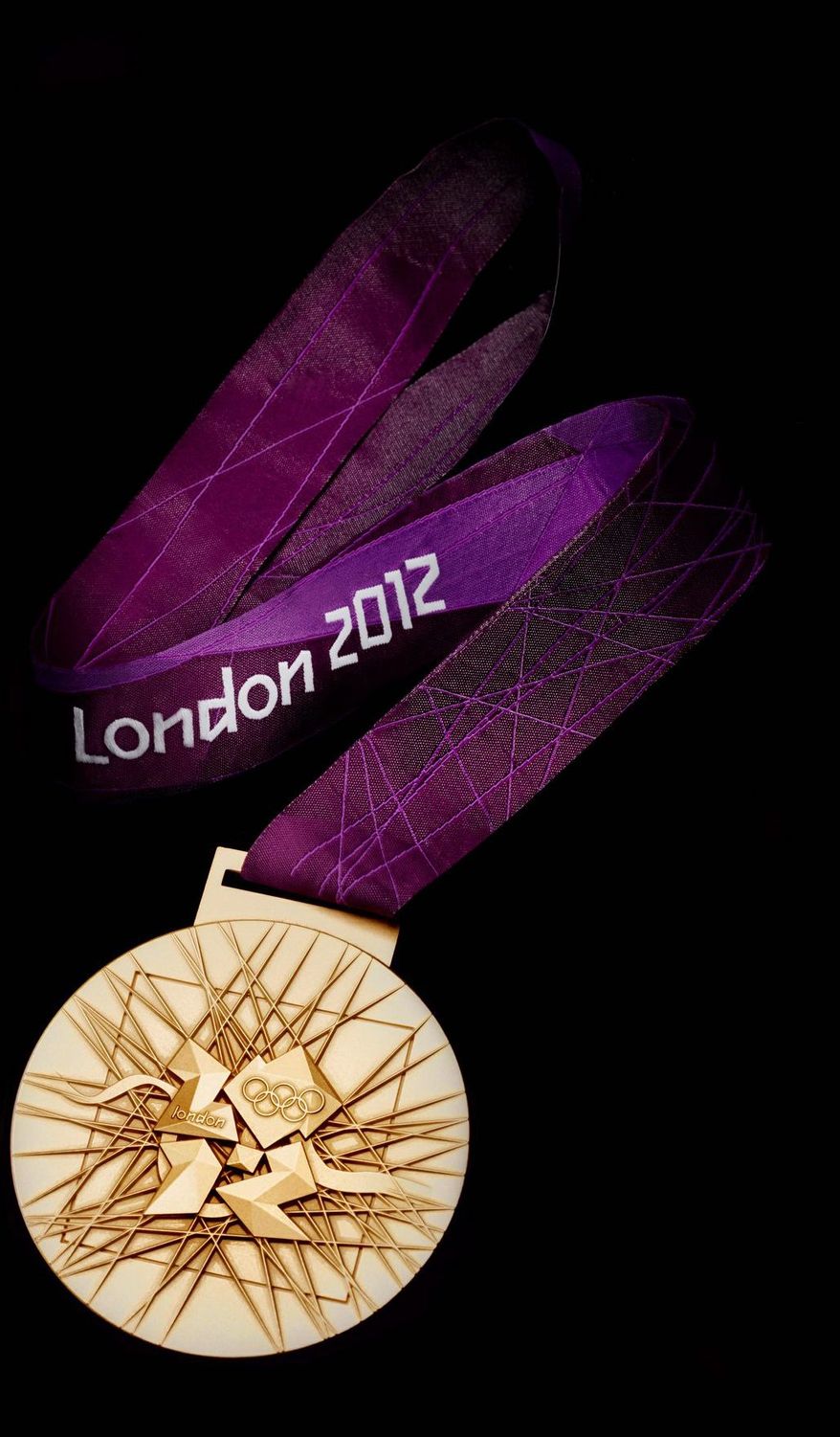 In this image made available by the London Organising Committee of the Olympic Games on Wednesday July 27, 2011 shows the London 2012 Olympic gold medal designed by British artist David Watkins. The back of the medal is displayed in this image all medals will be 85mm in diameter. With one year to go until the opening ceremony of the 2012 Olympic Games, London organizers completed the last of the Olympic Park's permanent venues Wednesday July 27, 2011 and promised to put on a safe and spectacular event that will captivate the world. (AP Photo/LOCOG, Ho)