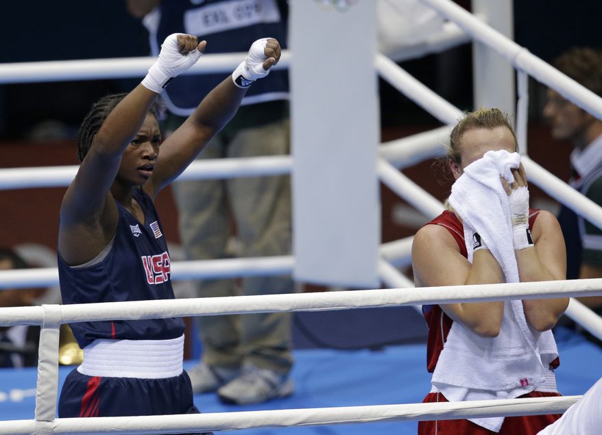 Claressa Shields (left) of the United States celebrates her victory over Kazakhstan's Marina Volnova in a middleweight 75 kg semifinal boxing match at the 2012 Summer Olympics in London on Wednesday, Aug. 8, 2012. (AP Photo/Patrick Semansky)