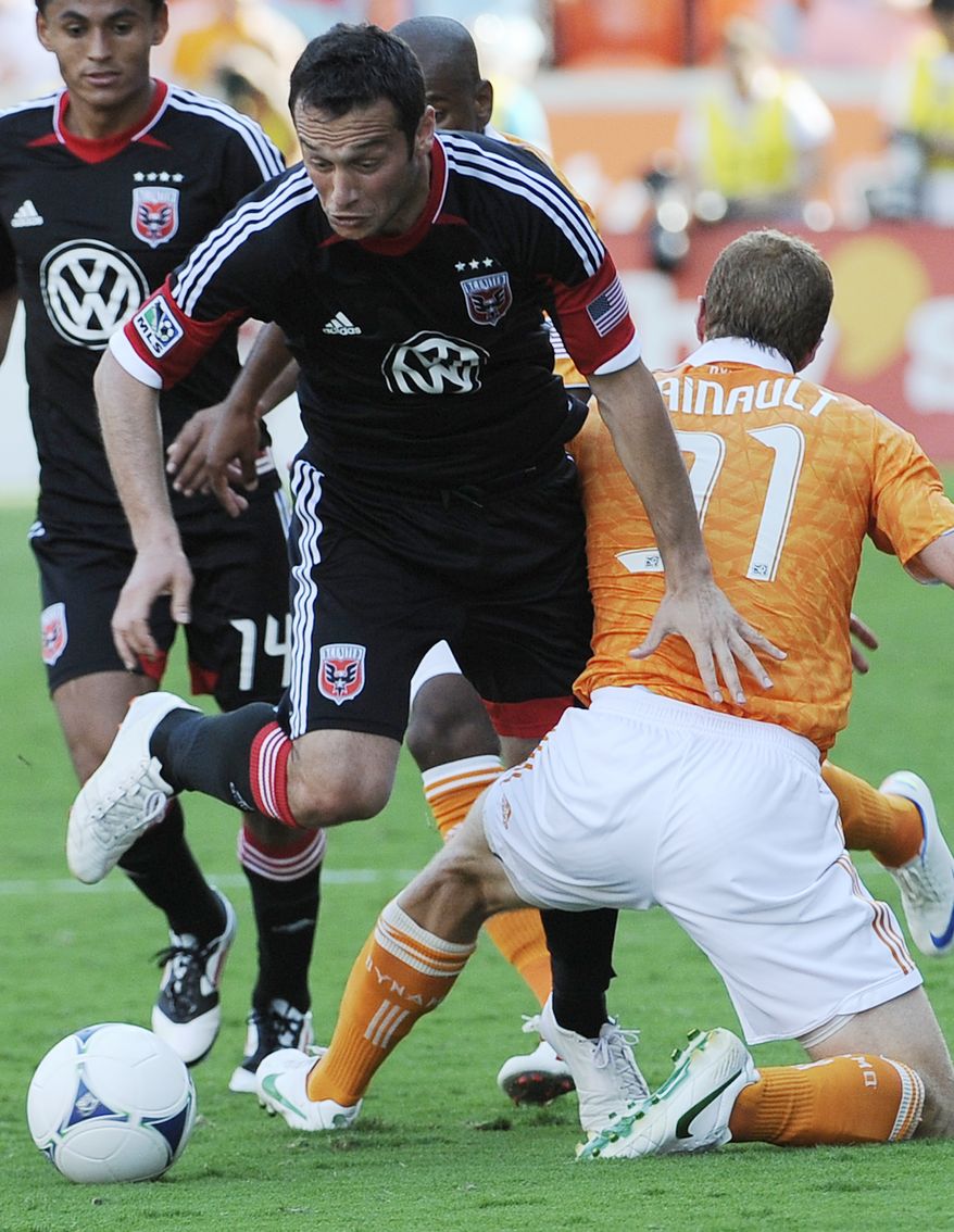 D.C. United's Hamdi Salihi, left, pushes past Houston Dynamo's Andre Hainault (31) during the second half of an MLS soccer match Saturday, May 12, 2012, in Houston. The Dynamo won 1-0. (AP Photo/Pat Sullivan)