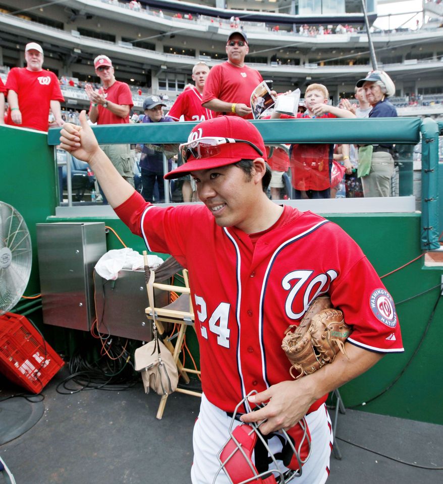 Nationals catcher Kurt Suzuki made some new friends in Washington by signing autographs after a game against Miami on Aug. 5. Suzuki had been acquired from Oakland two days earlier. (Associated Press)