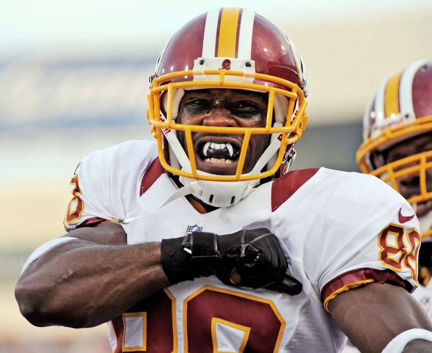 Redskins receiver Pierre Garcon celebrates his touchdown Thursday at Buffalo. Garcon caught three passes totaling 58 yards in the 80-yard drive. (Associated Press)